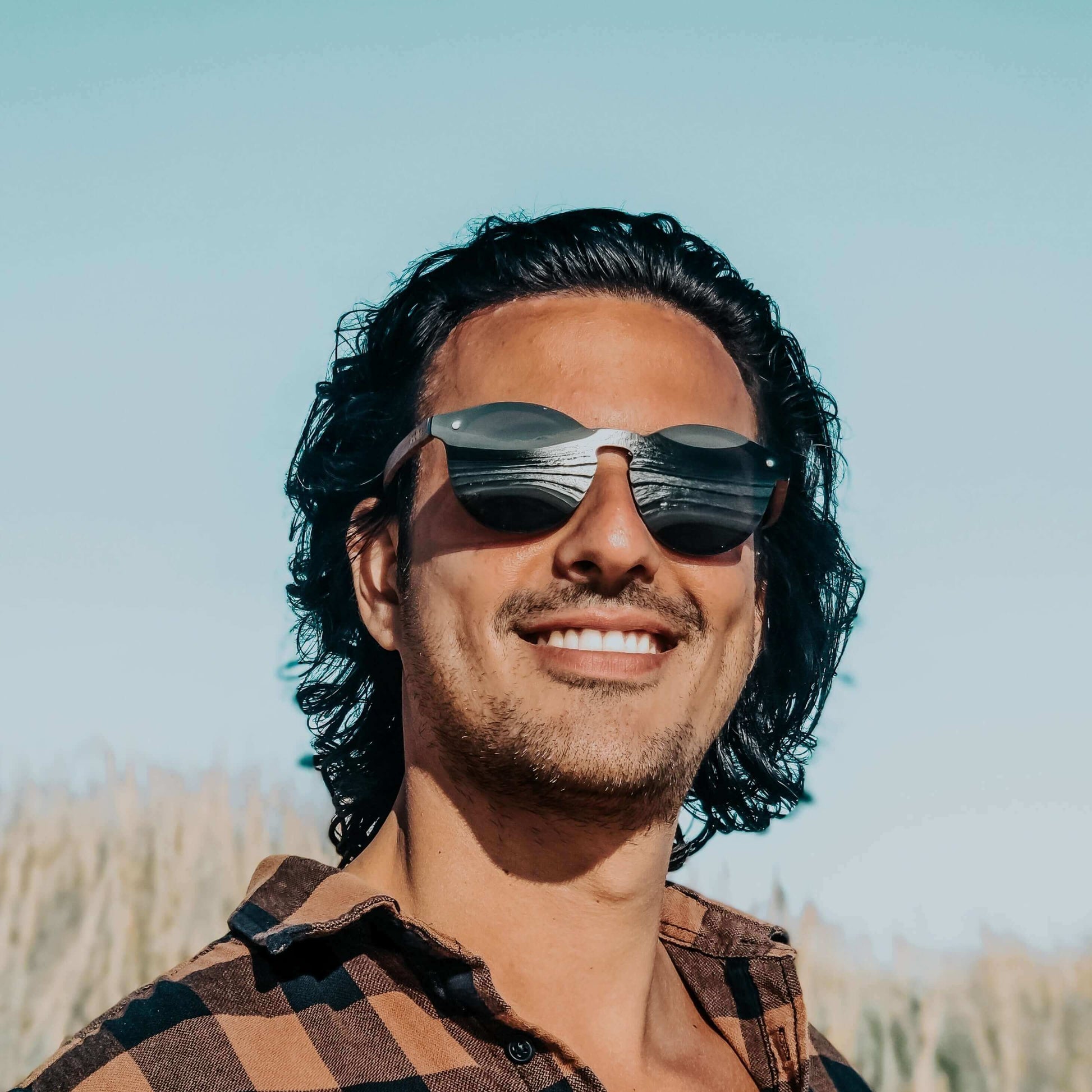 Man wearing sunglasses with a blurred natural background