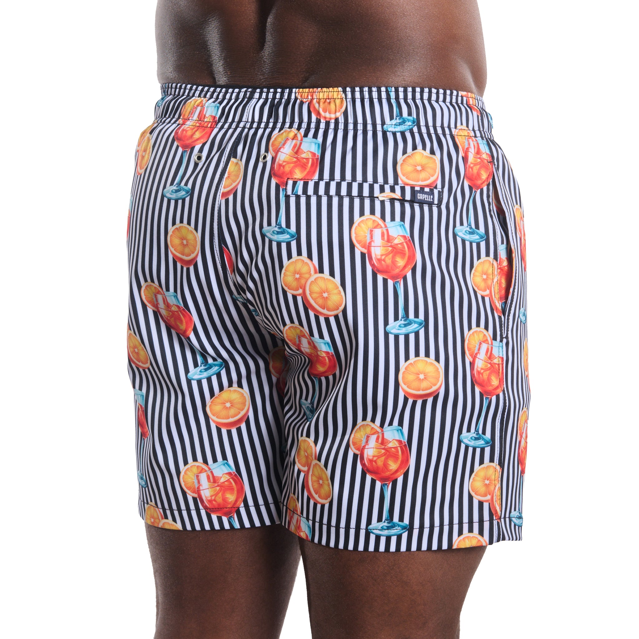 Sunset Spritz, Surf and Storm men's hybrid swim short in a black and white stripe with a cocktail print, back view