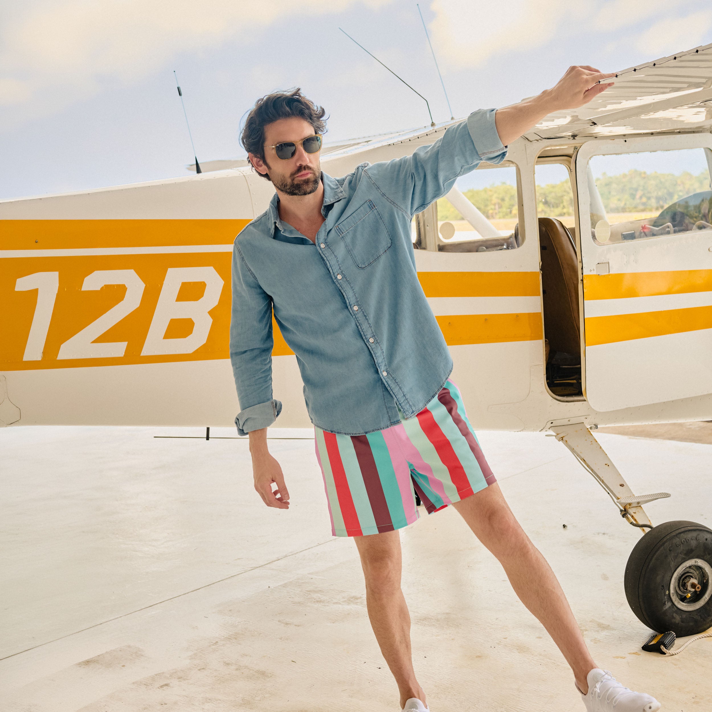Man in Coastal Cabana Zest hybrid swim shorts, a multicolor cabana stripe