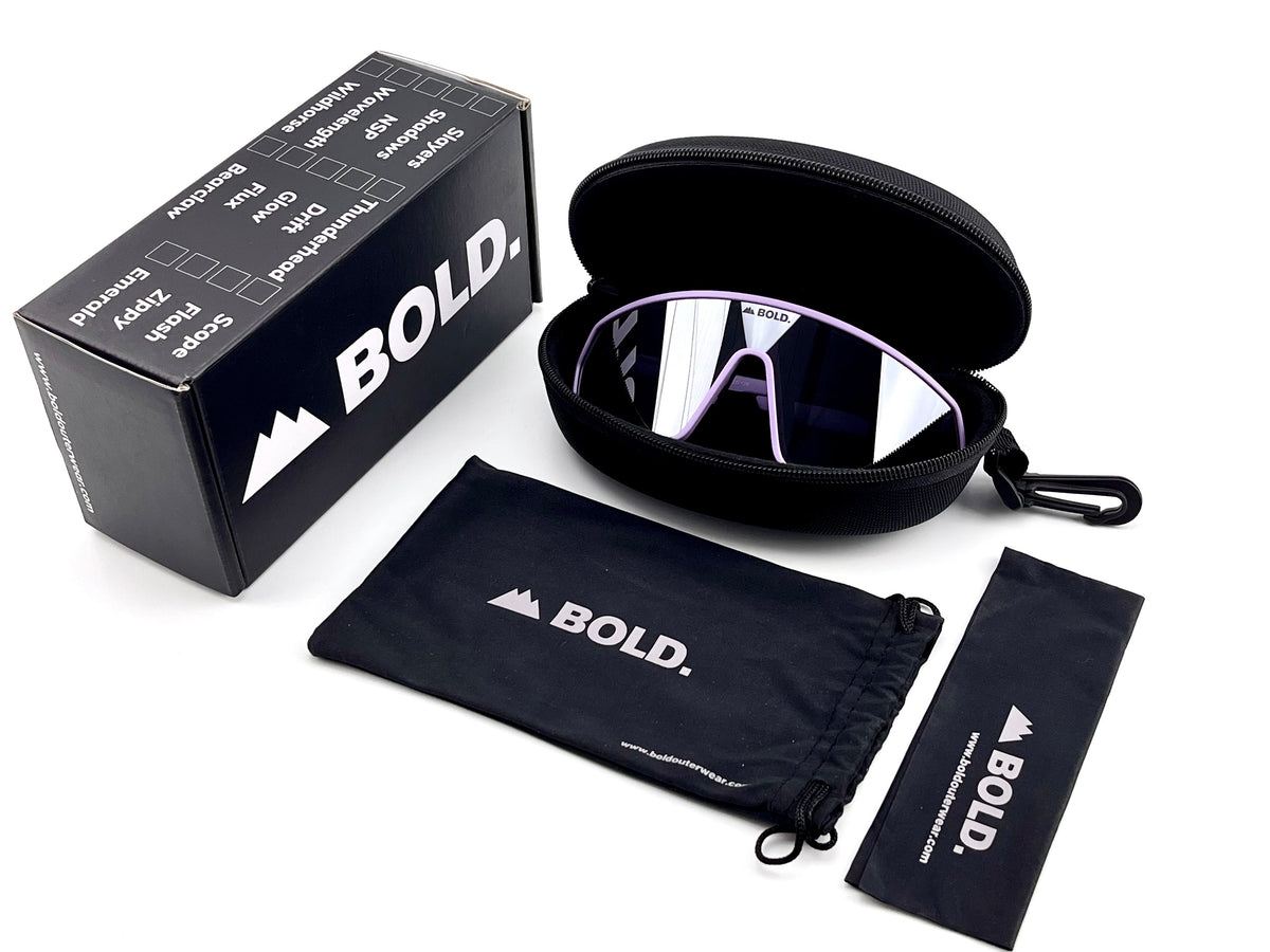 BOLD NSP low-profile sunglasses in purple with the BOLD box, zip case and cleaning pouch