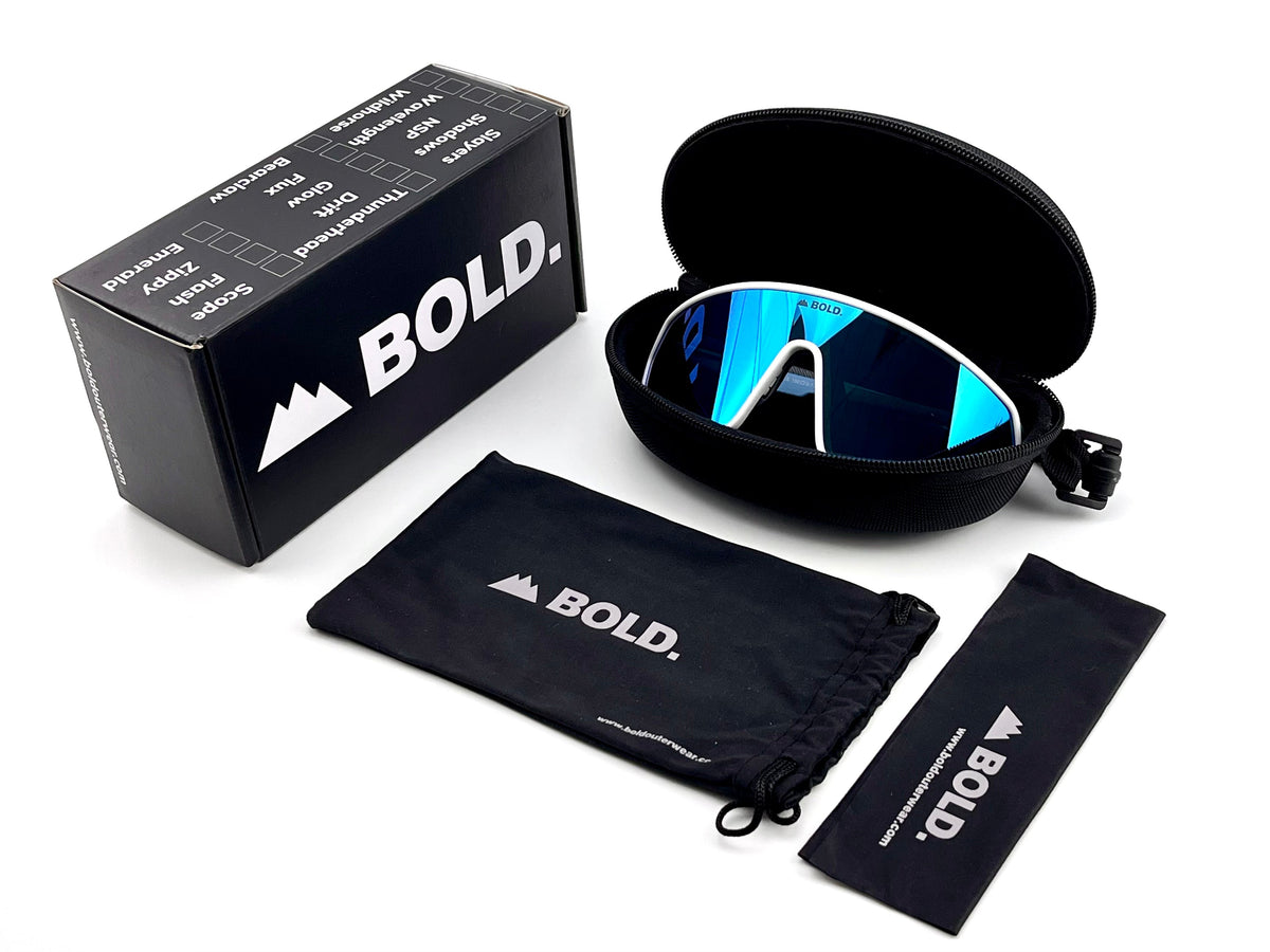 BOLD NSP low-profile sunglasses in blue with the BOLD box, zip case and cleaning pouch