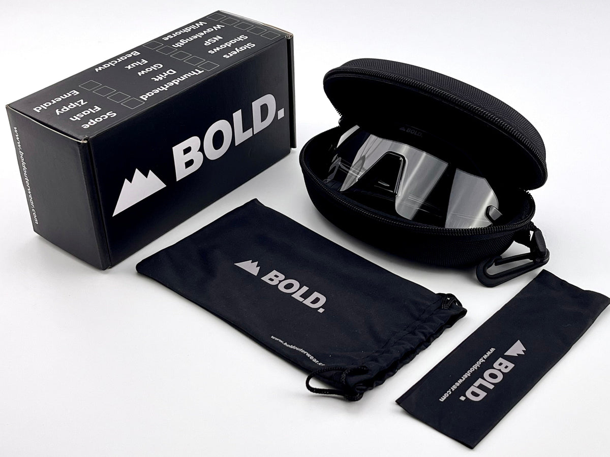 BOLD Emerald rimless photochromic sunglasses in black with the BOLD box, zip case and cleaning pouch