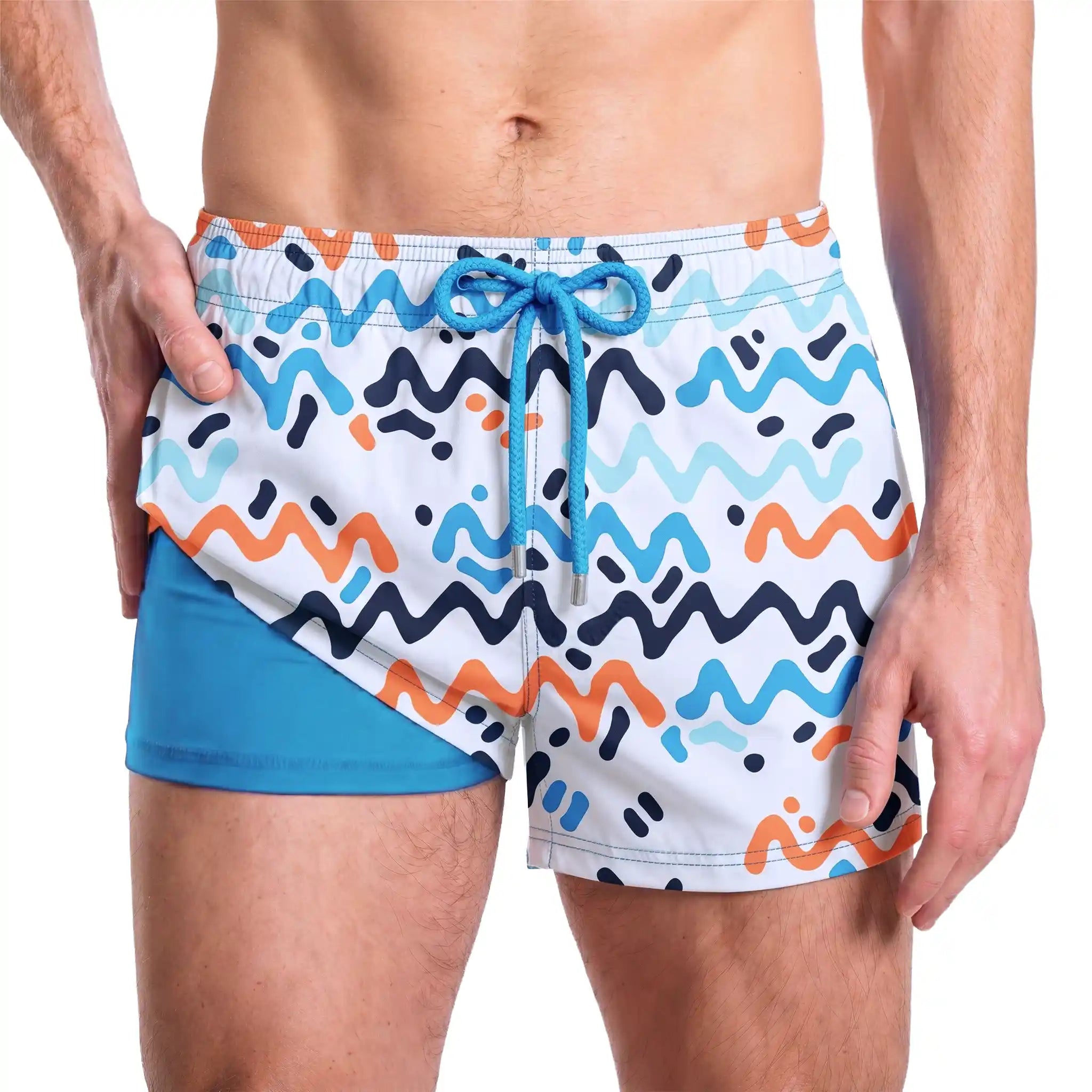 Line Rush, Ocean and Sol hybrid swim short in the 3 inch Short, navy, aqua and coral zigzag print, showing the built-in compression liner
