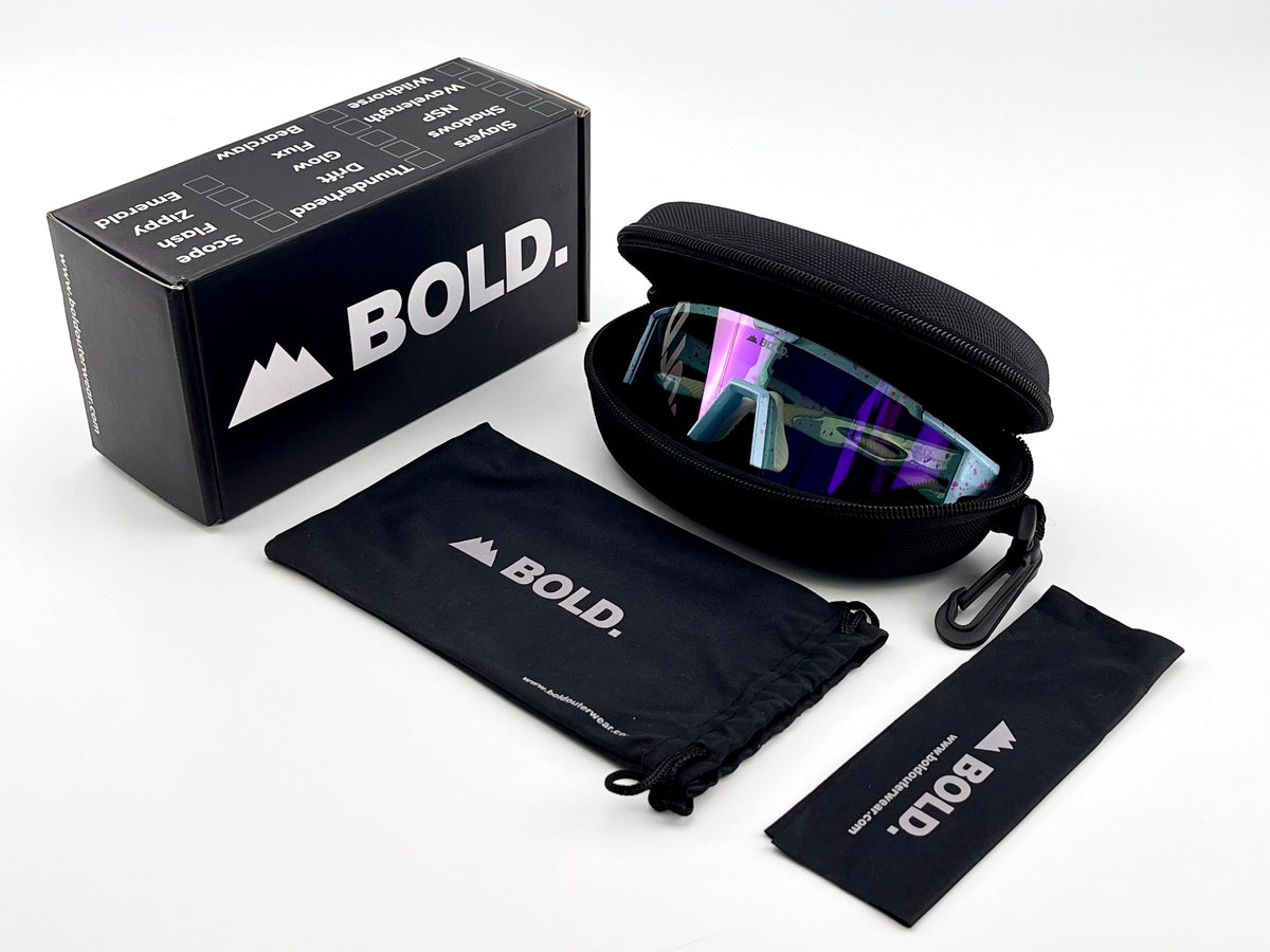 BOLD Wavelength photochromic shield sunglasses in blue with the BOLD box, zip case and cleaning pouch