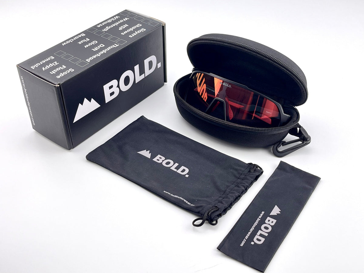 BOLD Slayers oversized photochromic sunglasses in red and black with the BOLD box, zip case and cleaning pouch