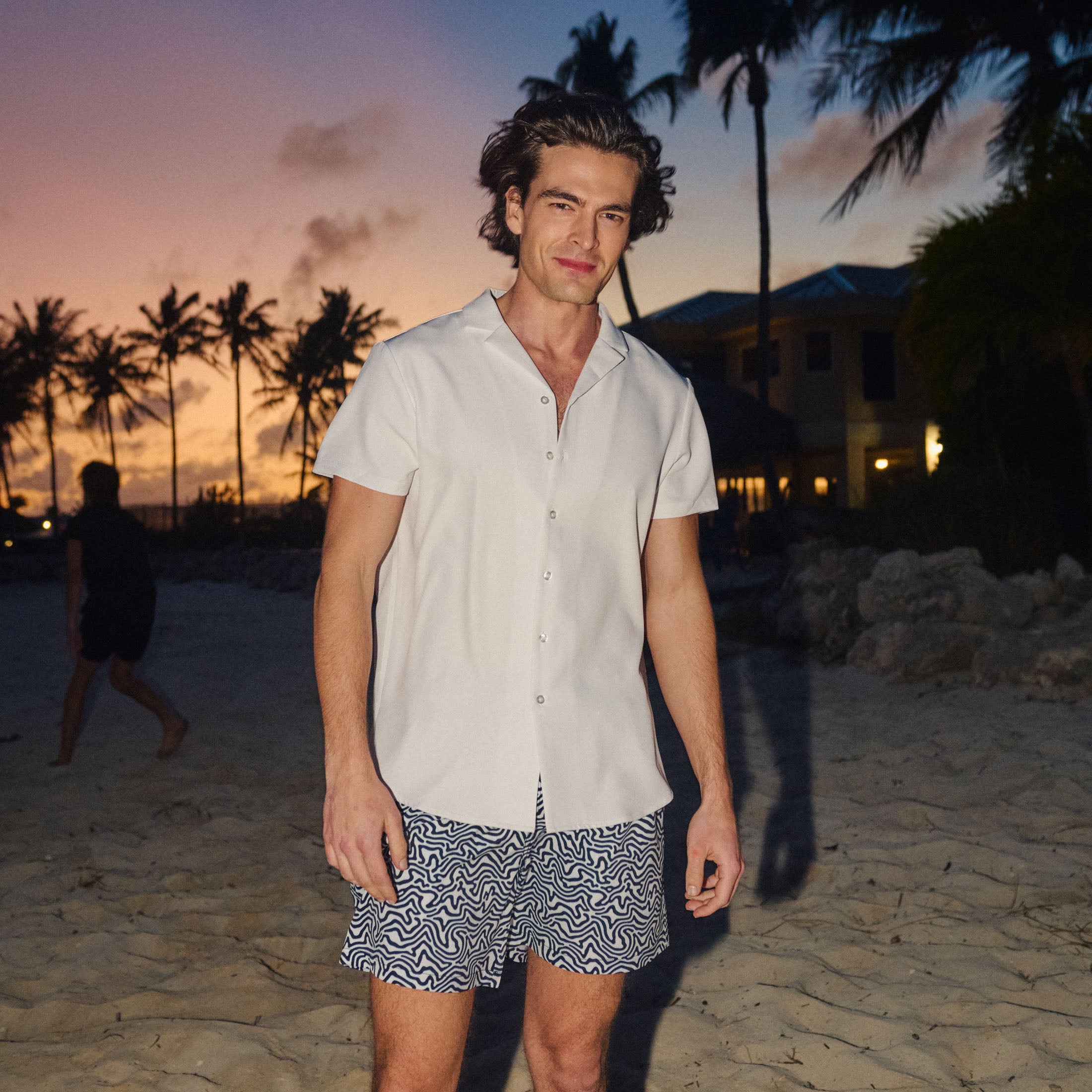 Man in an Arctic White resort shirt worn open, outdoors