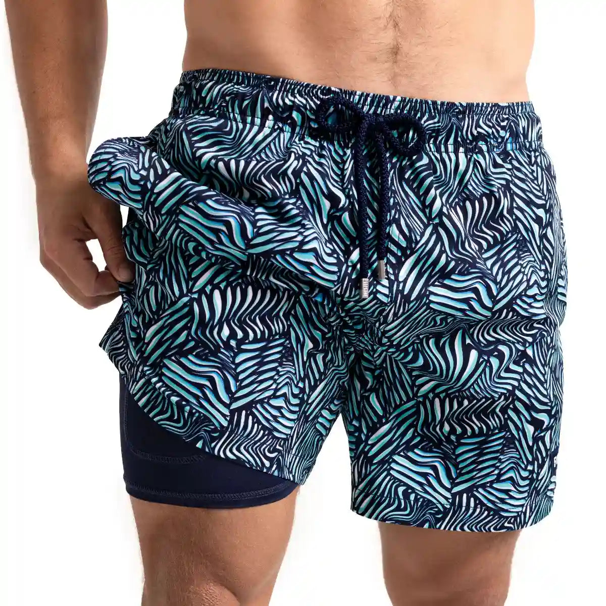 Beta Blue men's hybrid swim short, navy with an aqua and white tropical leaf print, front view showing the navy compression liner