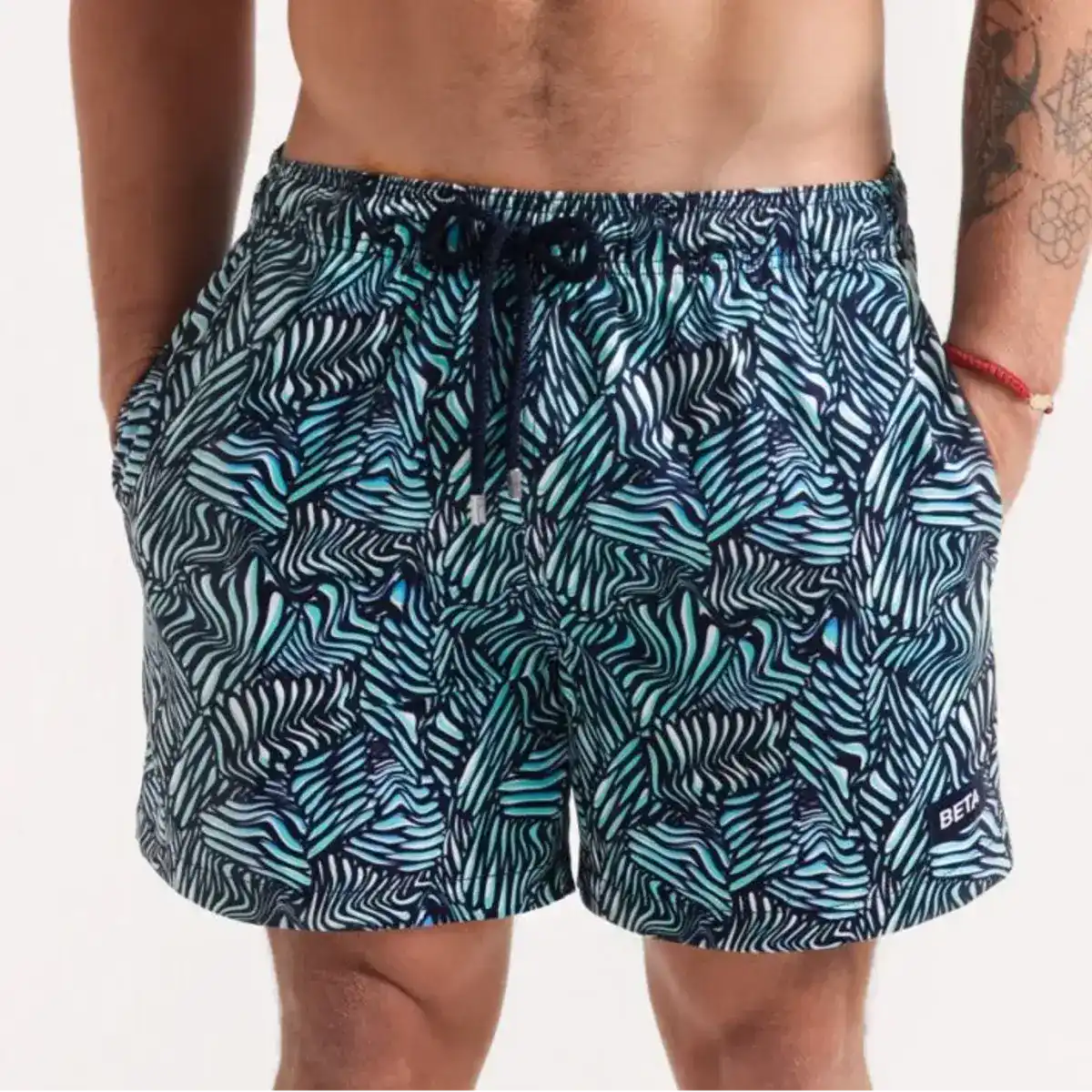 Beta Blue men's hybrid swim short in navy with an aqua and white leaf print, front view, second angle