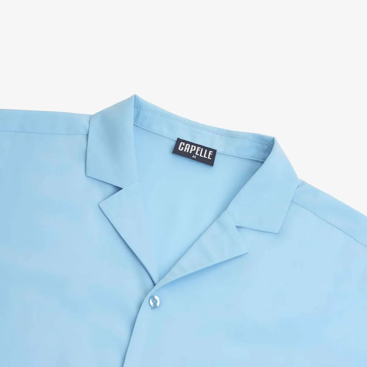 Close-up of the Blue Azure resort shirt fabric and button placket in pale sky blue