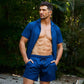 Man in a Blue Sapphire resort shirt worn open