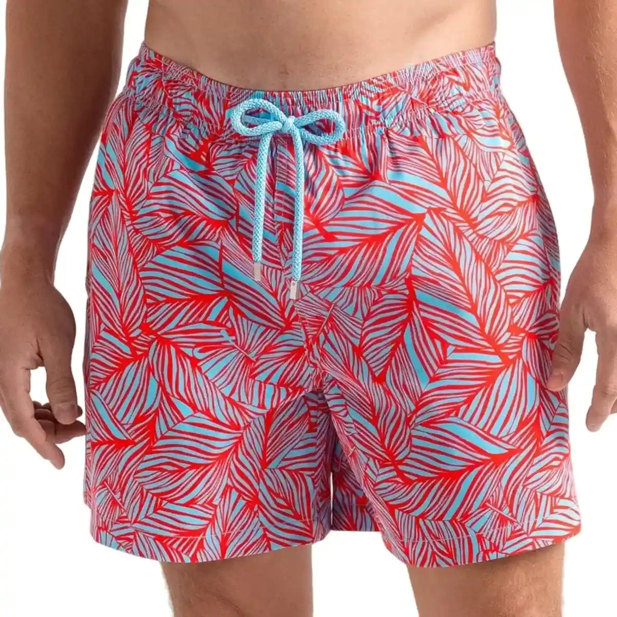 Captive men's hybrid swim short in a coral and pale blue tropical leaf print, front view, second angle