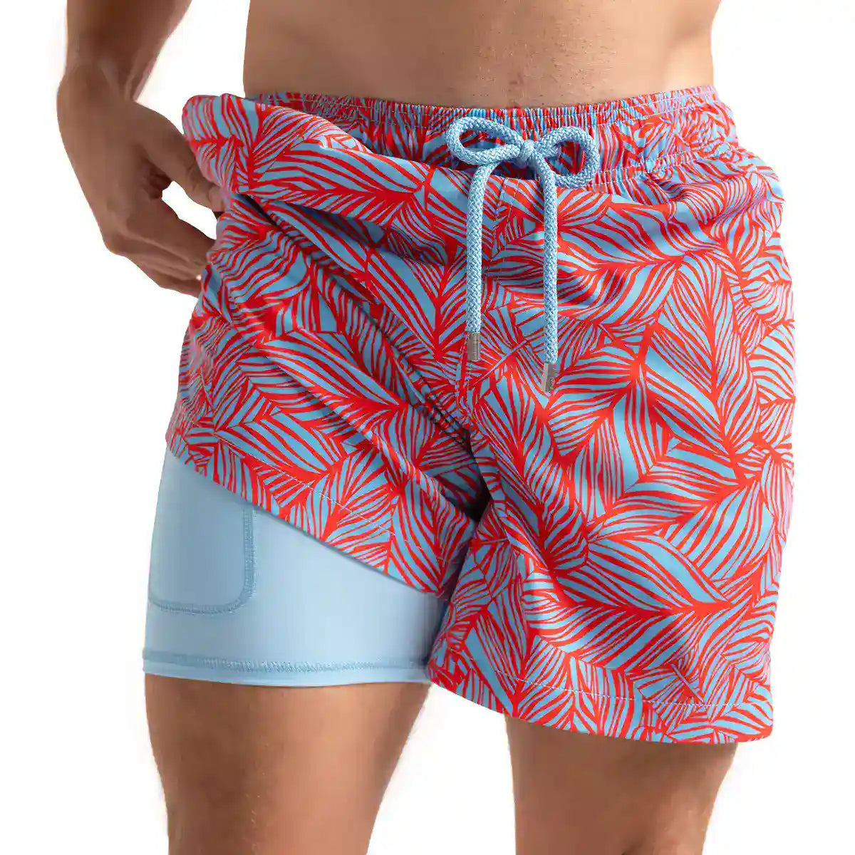 Captive men's hybrid swim short, coral red and pale blue tropical leaf print with a light blue drawstring, front view showing the light blue compression liner