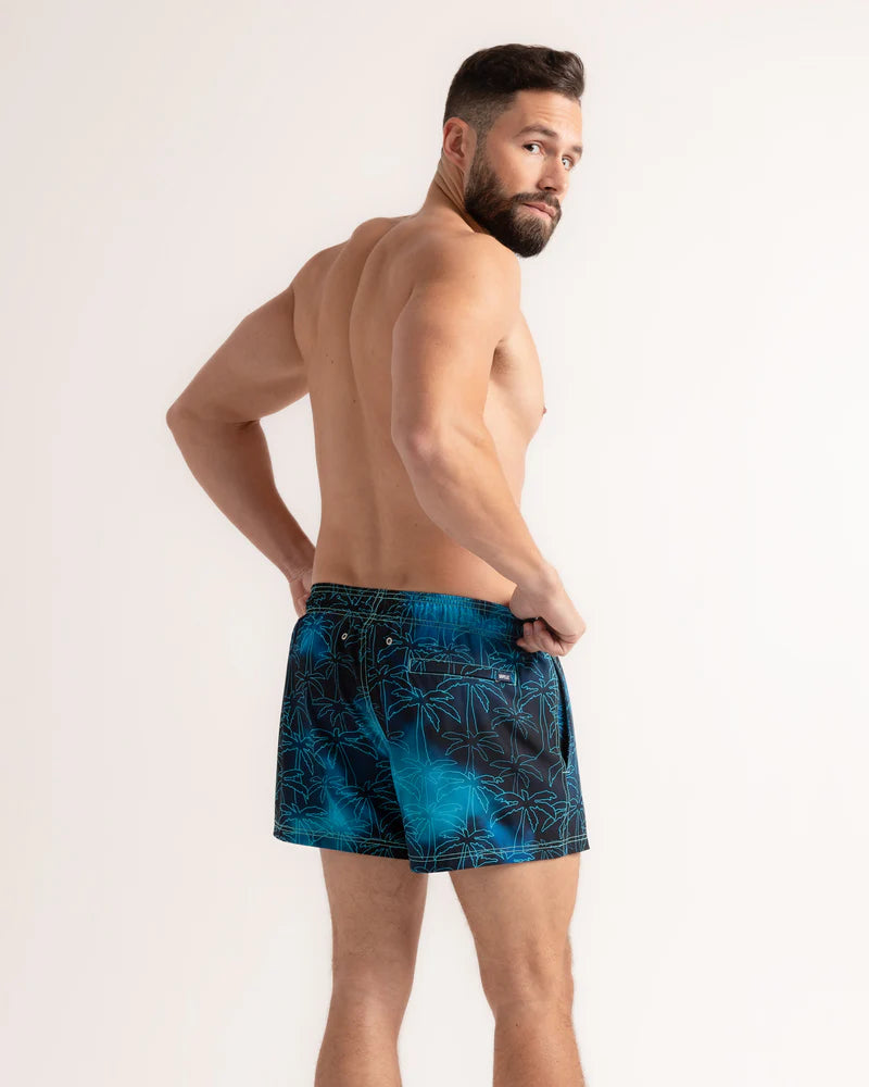 Foggy Palms men's hybrid swim short in the 3 inch Short, navy with a turquoise palm print, back view