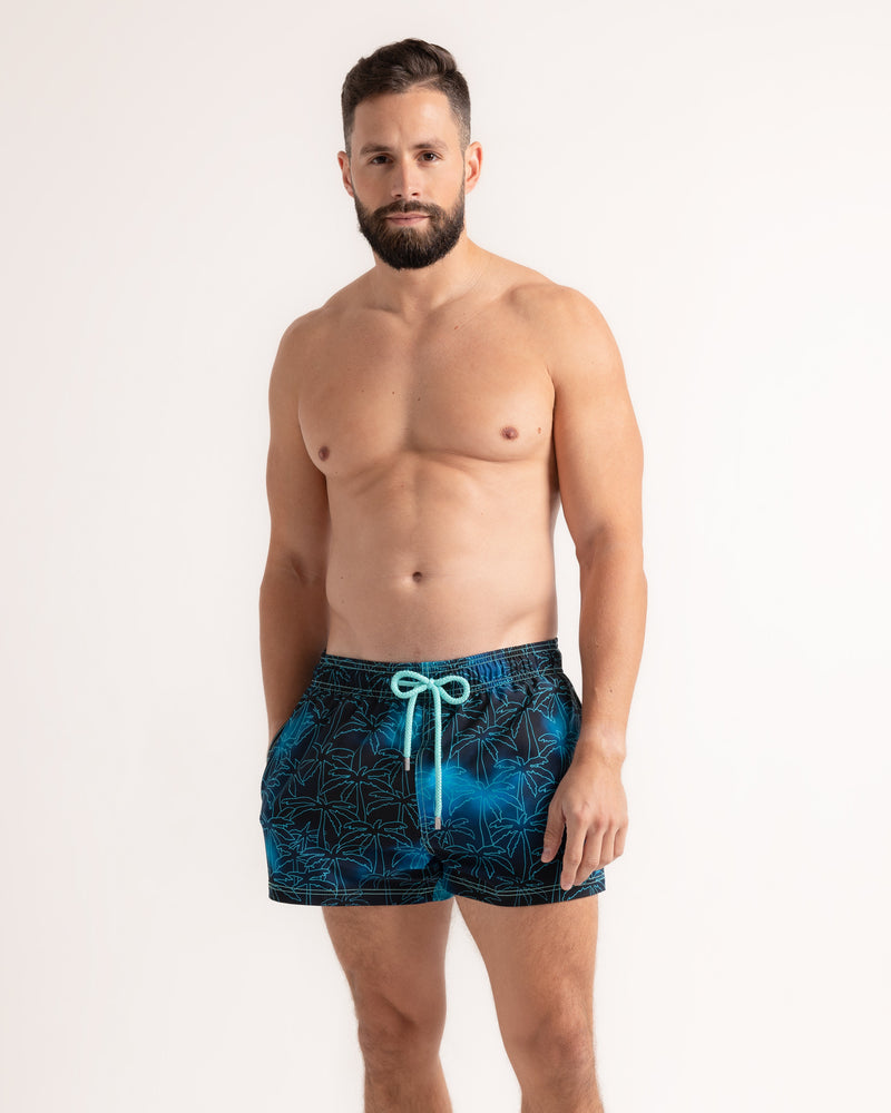 Foggy Palms men's hybrid swim short in the 3 inch Short, navy with a turquoise palm print, front view