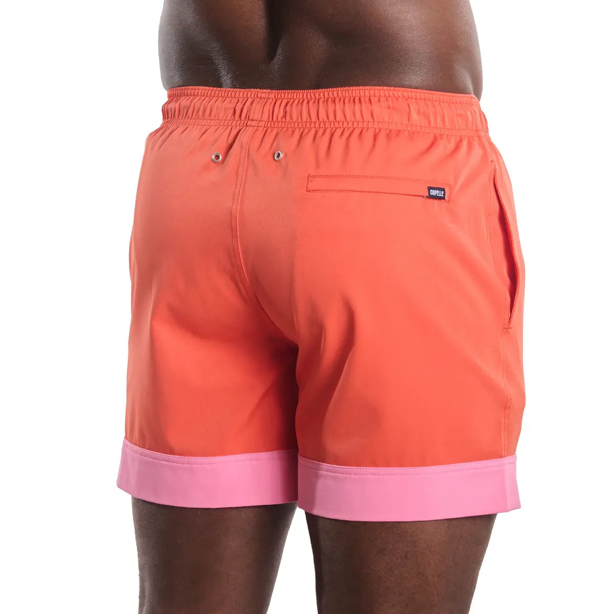 Coral Flame men's hybrid swim short in solid coral orange, back view