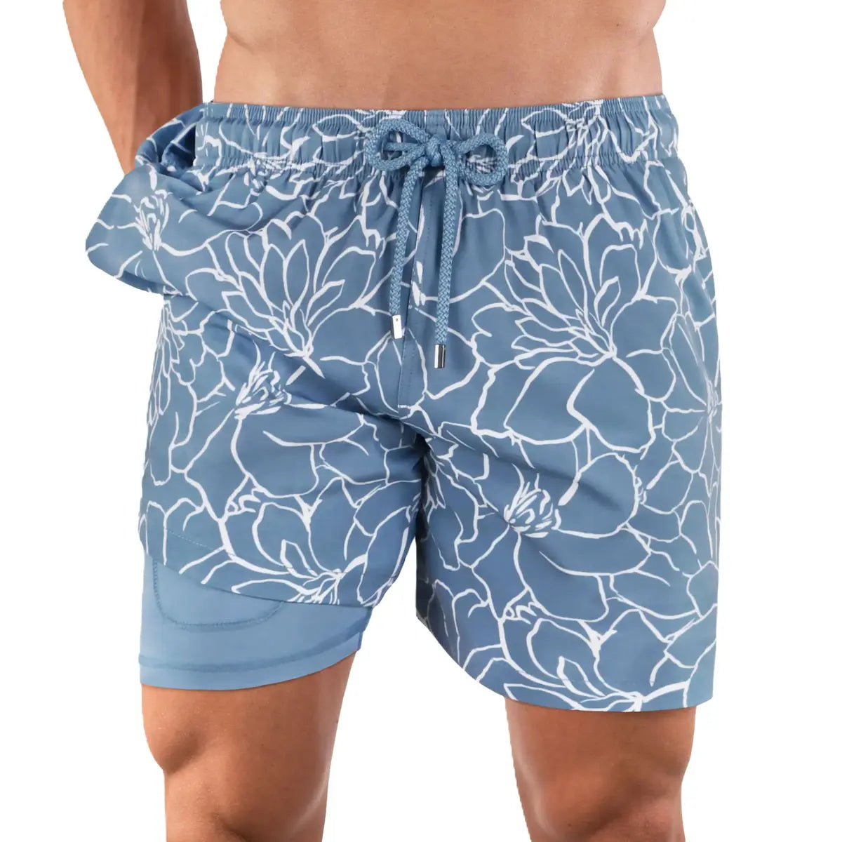 Early Bloom men's hybrid swim short, dusty blue with a white outlined magnolia print and blue drawstring, front view showing the blue compression liner