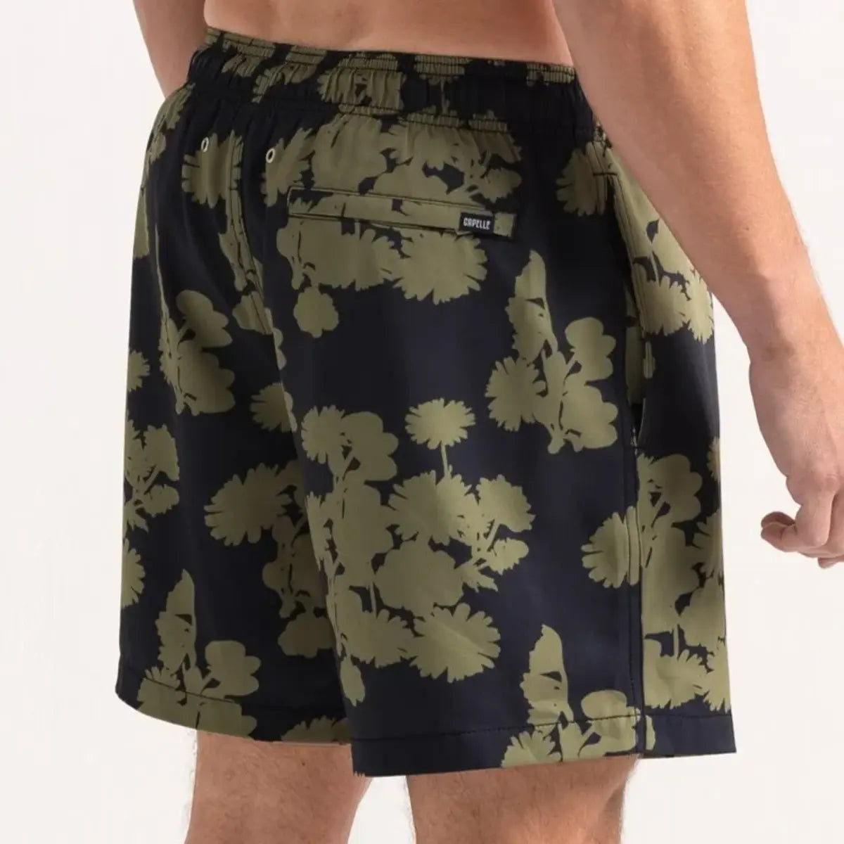 Foliage men's hybrid swim short in navy with an olive foliage print, back view