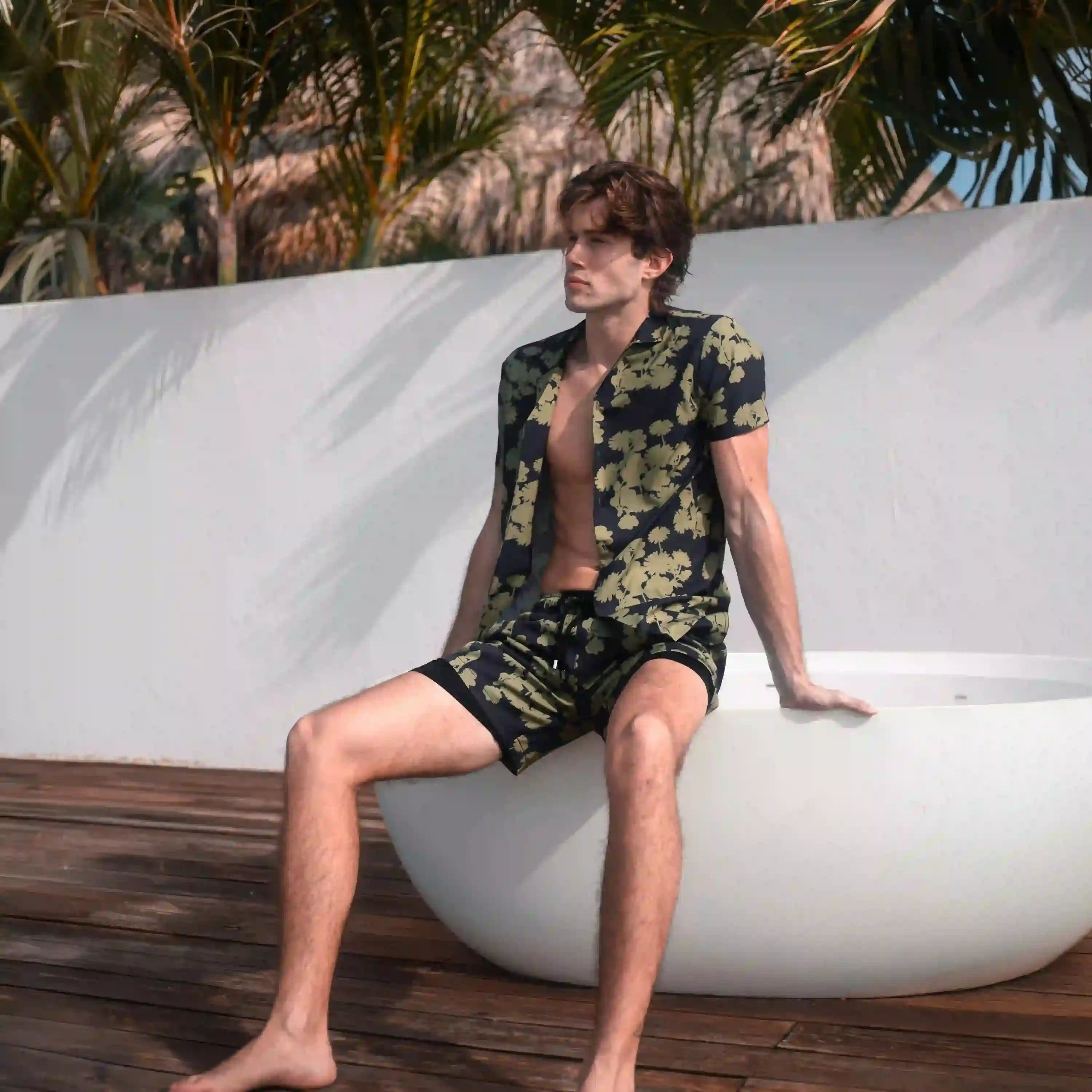 Man in Foliage hybrid swim shorts, navy with an olive foliage print
