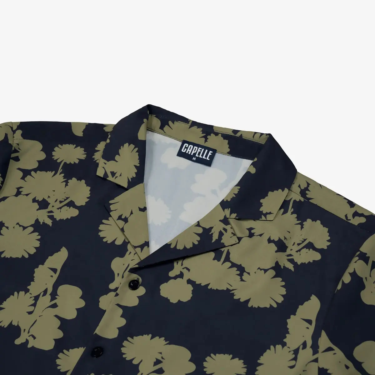 Close-up of the Foliage resort shirt fabric, navy with an olive foliage print