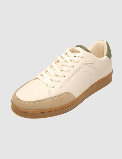 G West men's low-top sneaker in beige with a gum rubber sole and sage green heel tab, side view