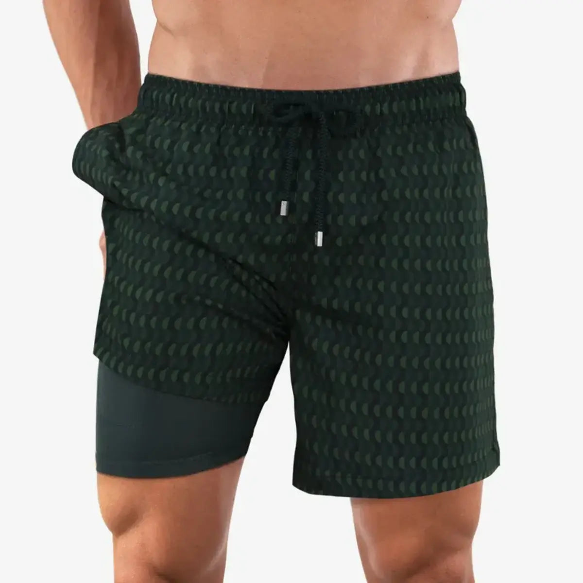 Ipanema men's hybrid swim short, dark forest green with a tonal scalloped geometric print, front view showing the green compression liner