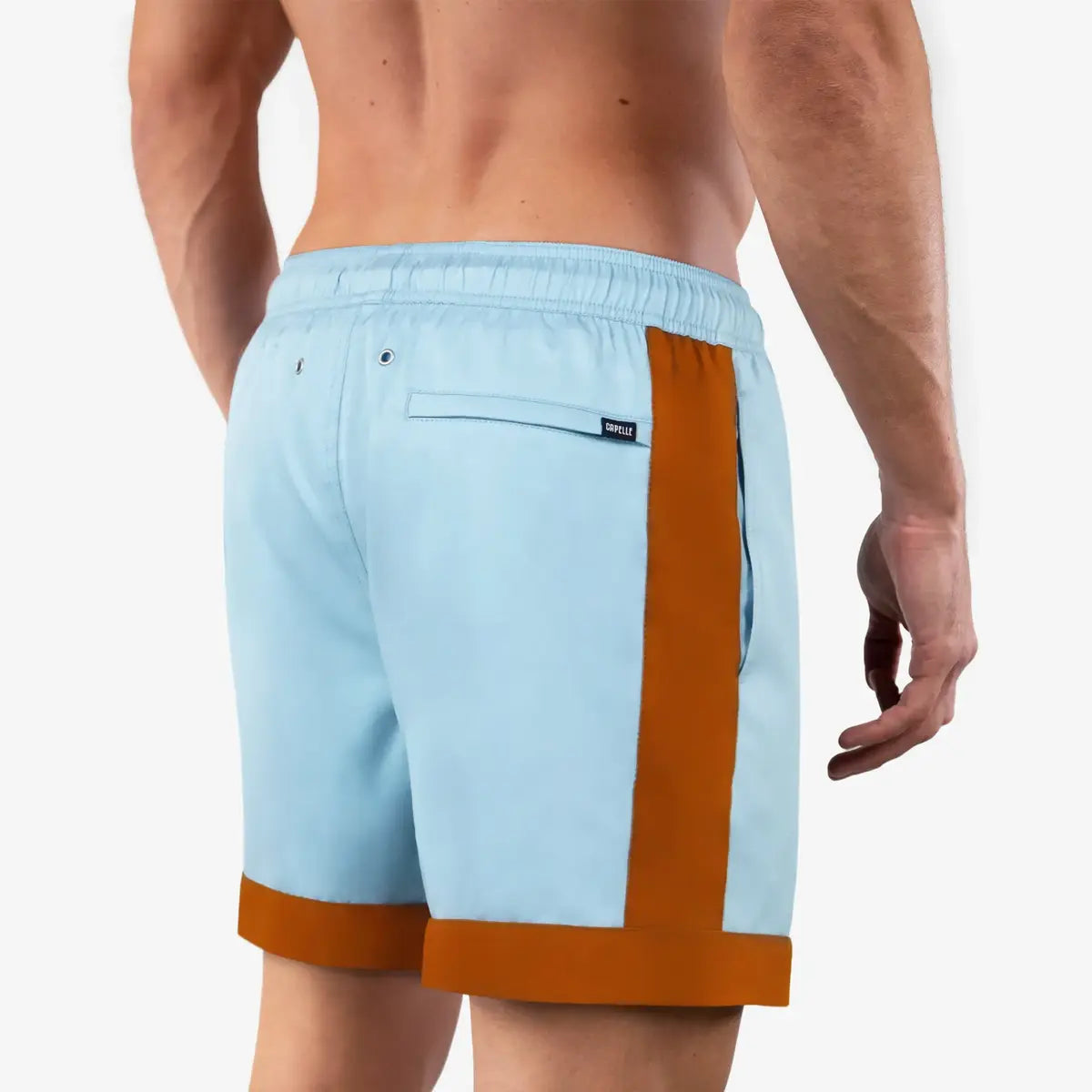 Ivo men's hybrid swim short in pale sky blue with a rust orange hem stripe, back view