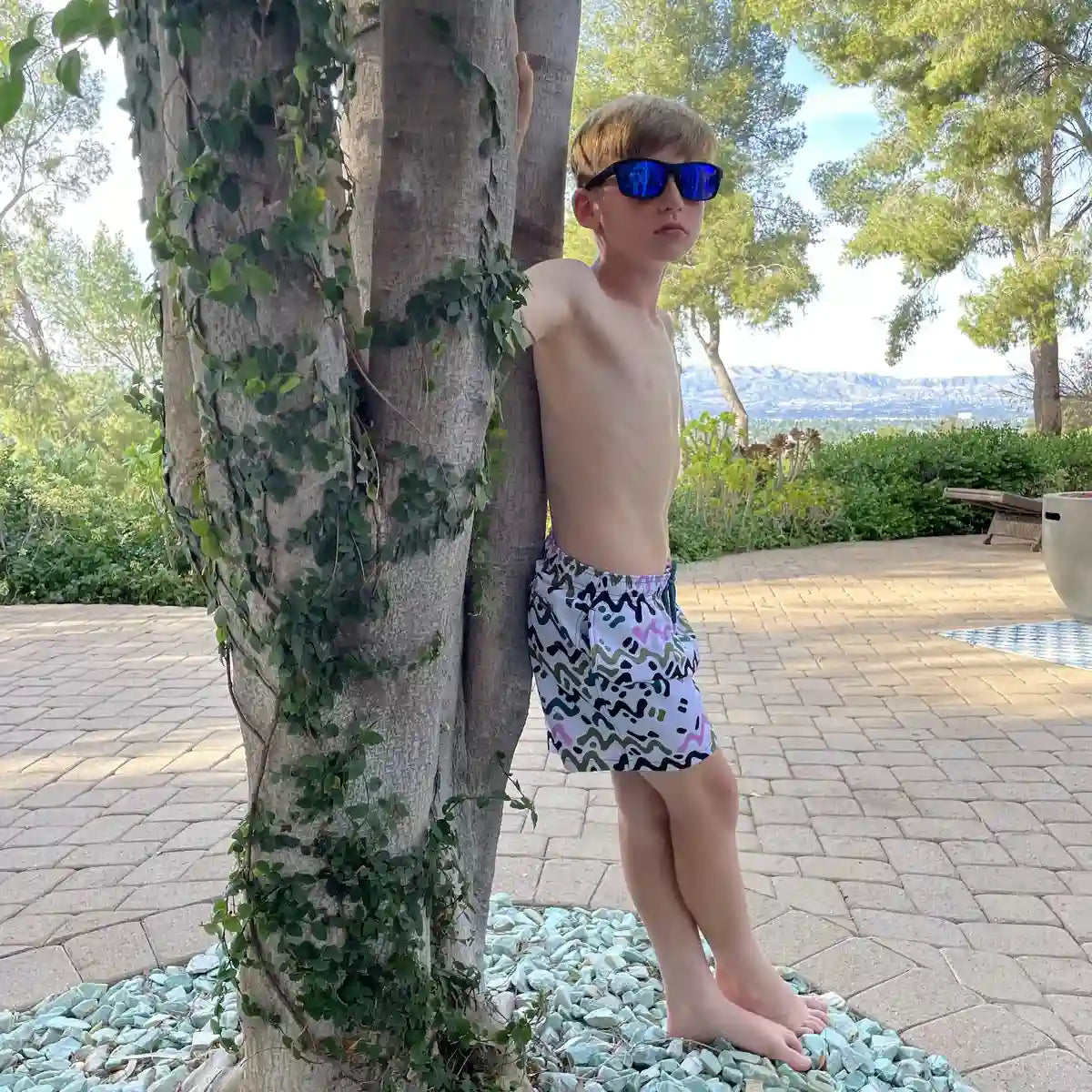 Line Rush, Orchid and Kelp boys hybrid short, worn on model