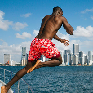 Man in Pink Flamingo hybrid swim shorts, a pink and red flamingo print