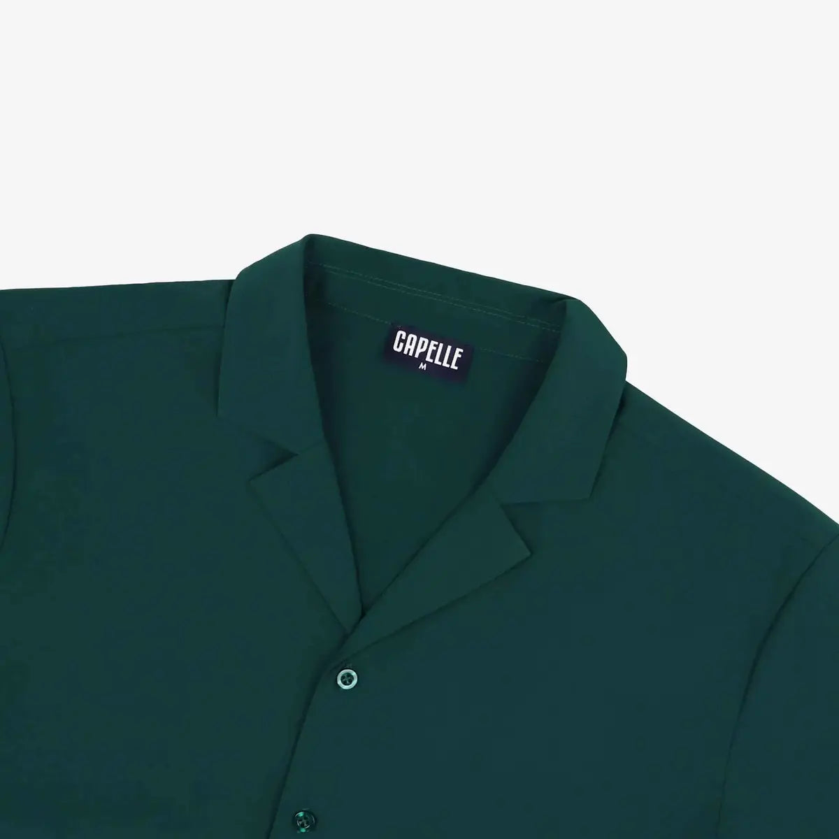 Close-up of the Night Green resort shirt fabric and button placket in deep pine green