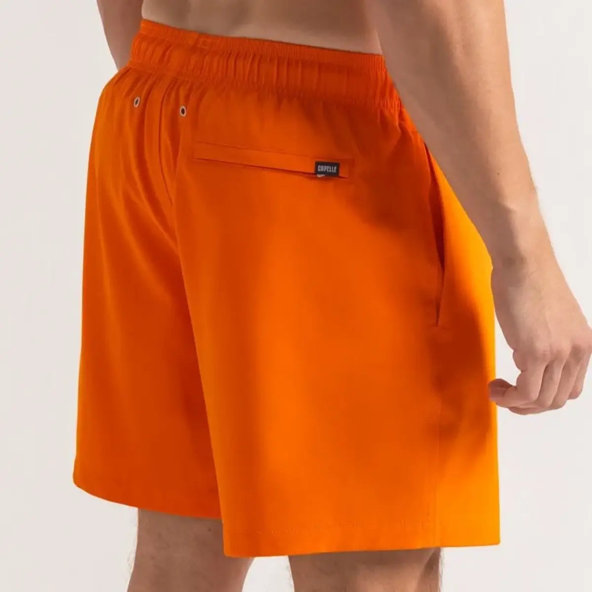 Orange Soda men's hybrid swim short in solid bright orange, back view