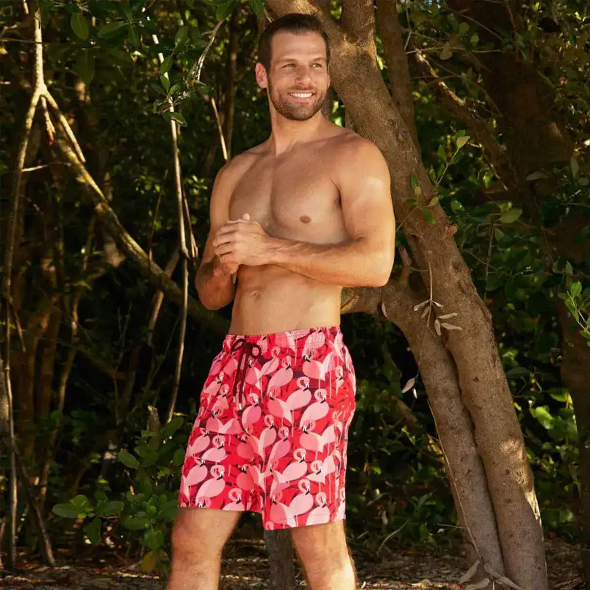 Man in Pink Flamingo hybrid swim shorts in the 9 inch Long, pink and red flamingo print