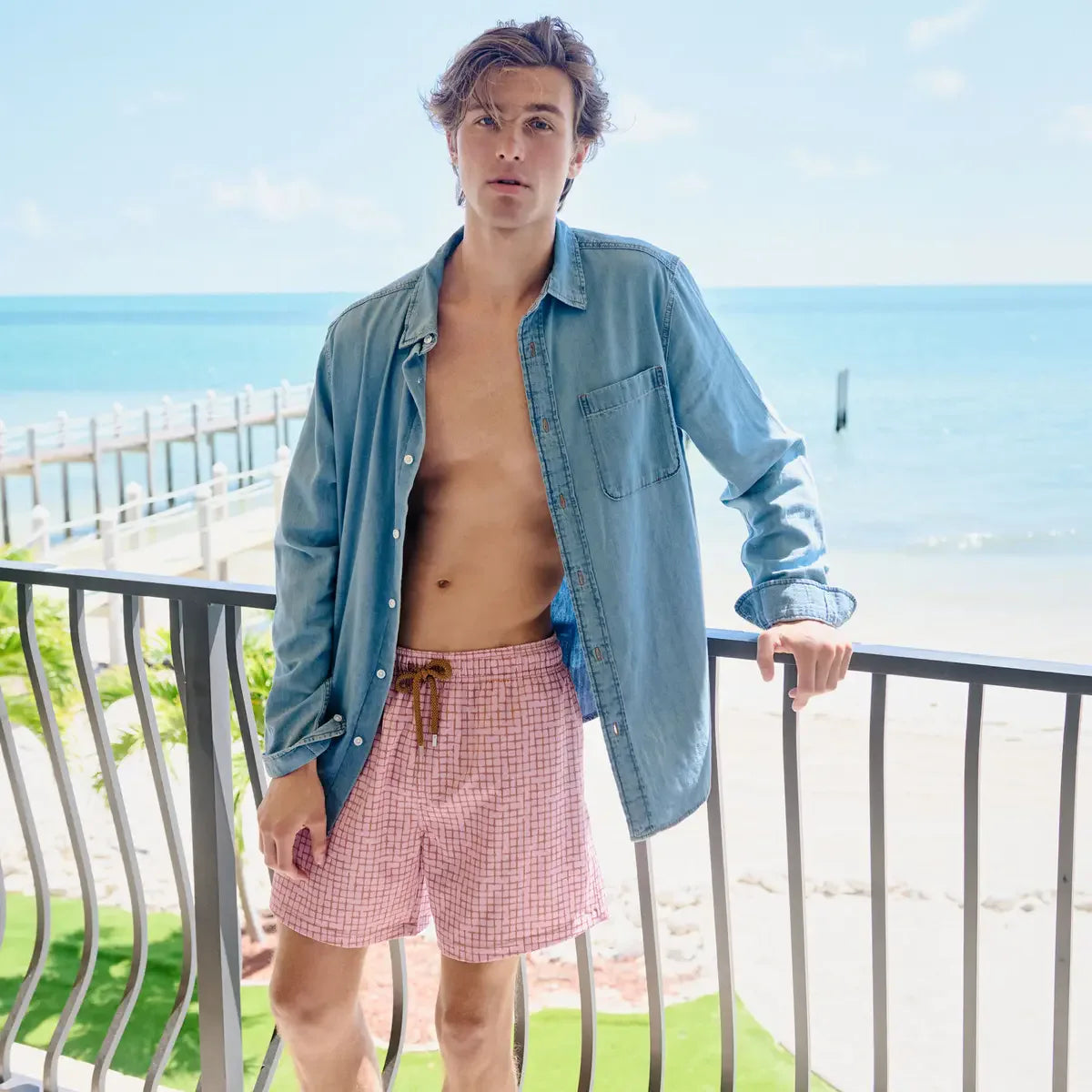 Man in Pixel Break Rosetide hybrid swim shorts, dusty pink with a tonal pixel grid check