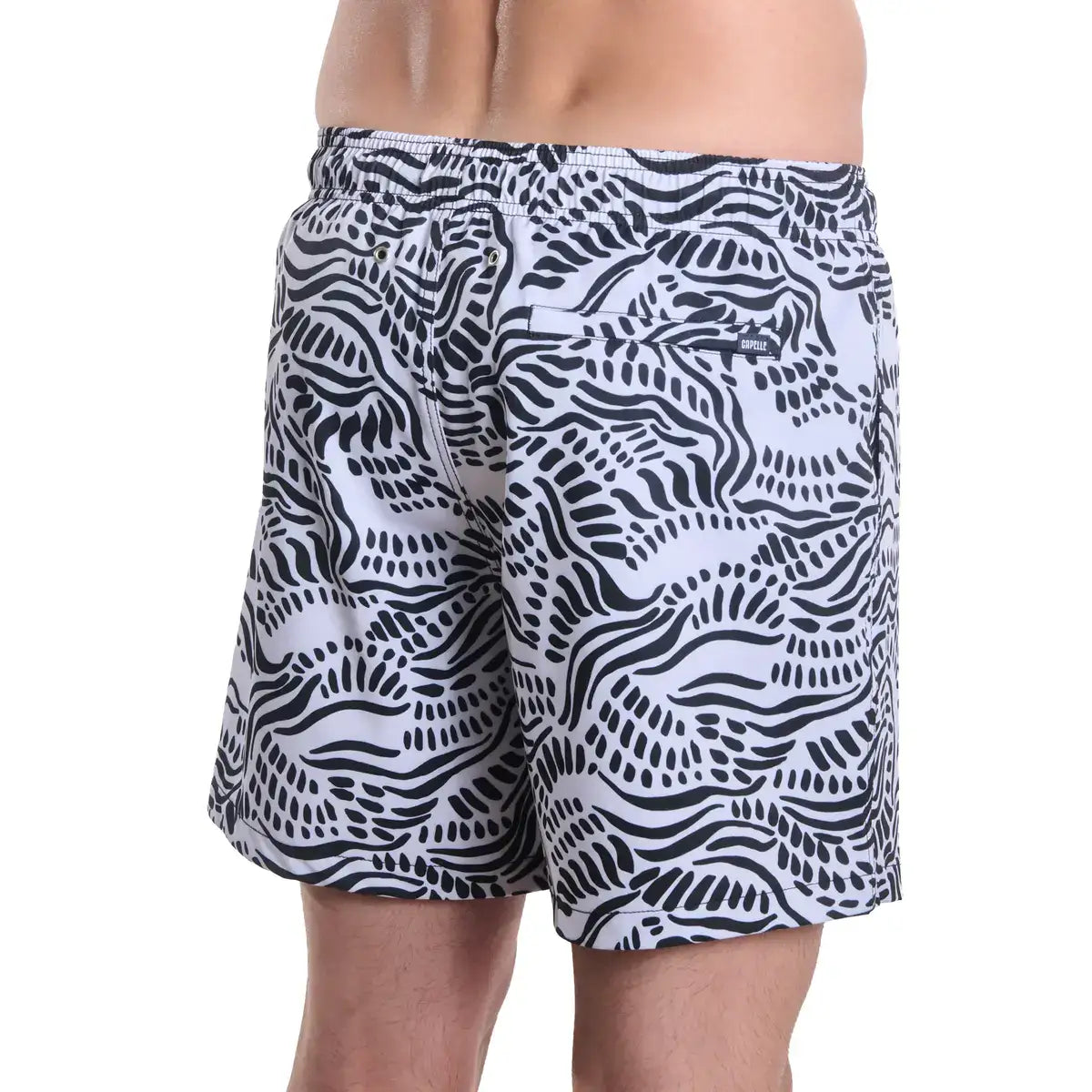 Salt Spray, Surf and Storm men's hybrid swim short in black with a white coral reef print, back view