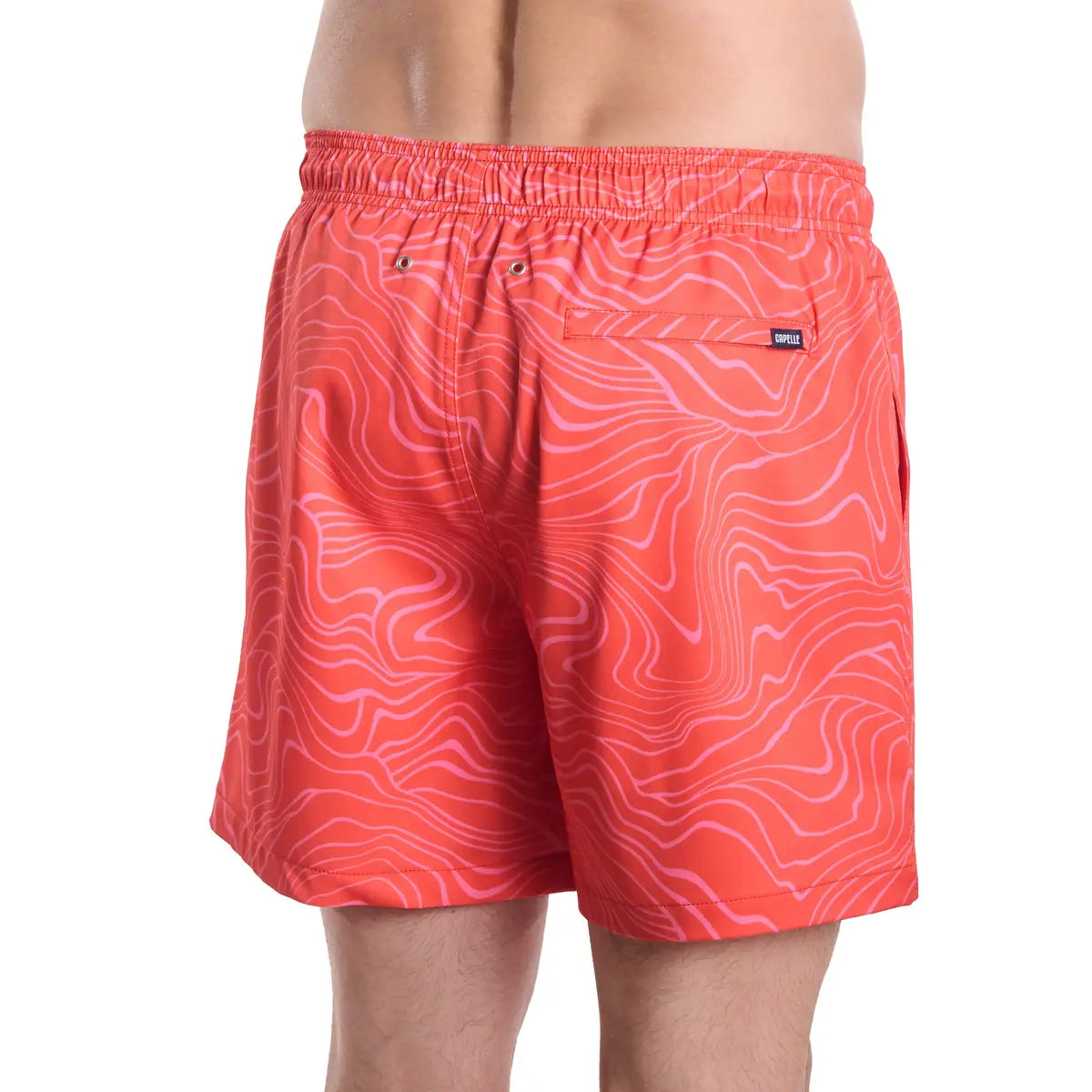 Sand Waves, Heat and Bloom men's hybrid swim short in coral with a tonal wave line print, back view