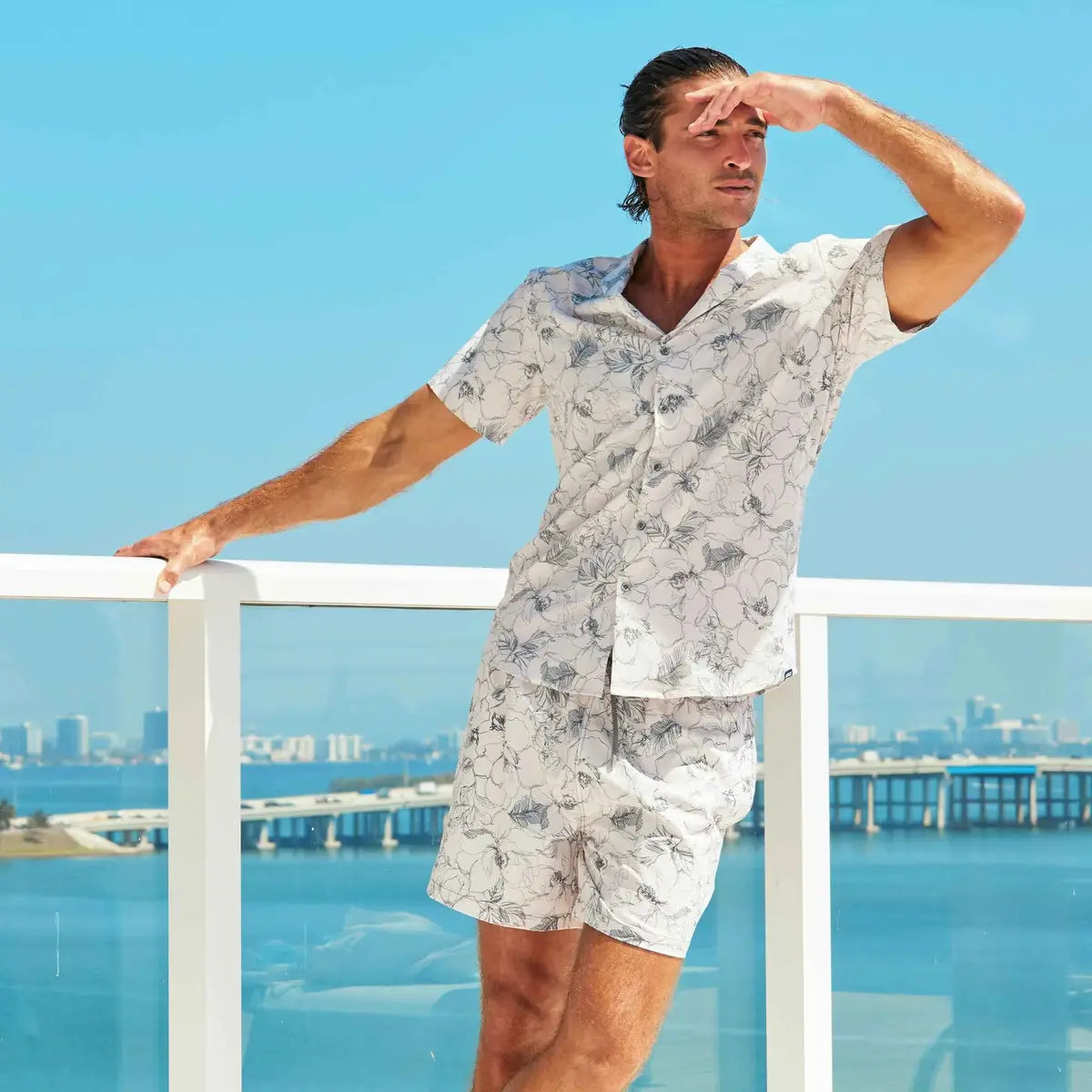 Man in a Secret Garden resort shirt and matching hybrid swim shorts, cream with a charcoal floral outline print