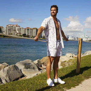 Man in a Secret Garden resort shirt worn open over matching Secret Garden hybrid swim shorts