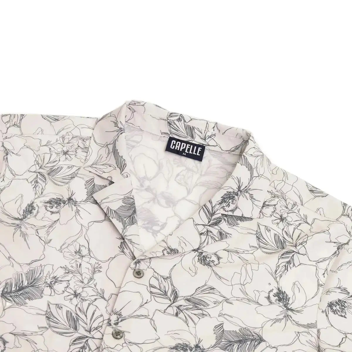 Close-up of the Secret Garden resort shirt fabric, cream with a charcoal floral outline print