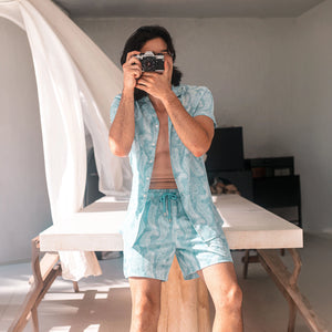 Man in Serenity hybrid swim shorts, pale aqua with a tonal leaf print