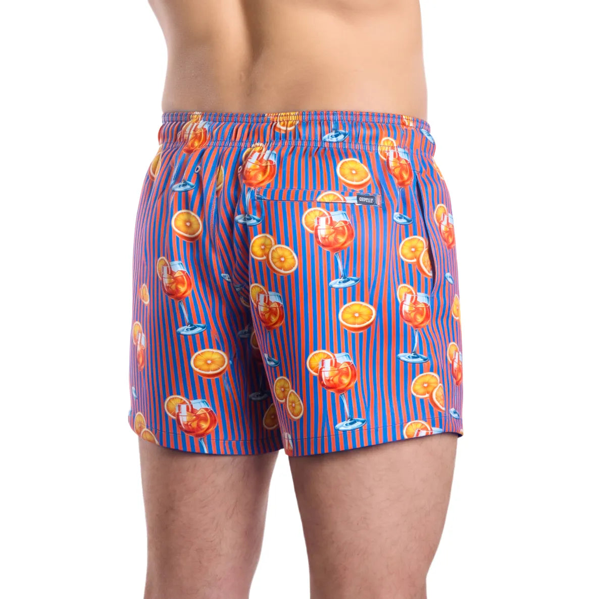 Sunset Spritz, Ocean and Heat men's hybrid swim short in the 3 inch Short, purple and coral stripe with a cocktail print, back view