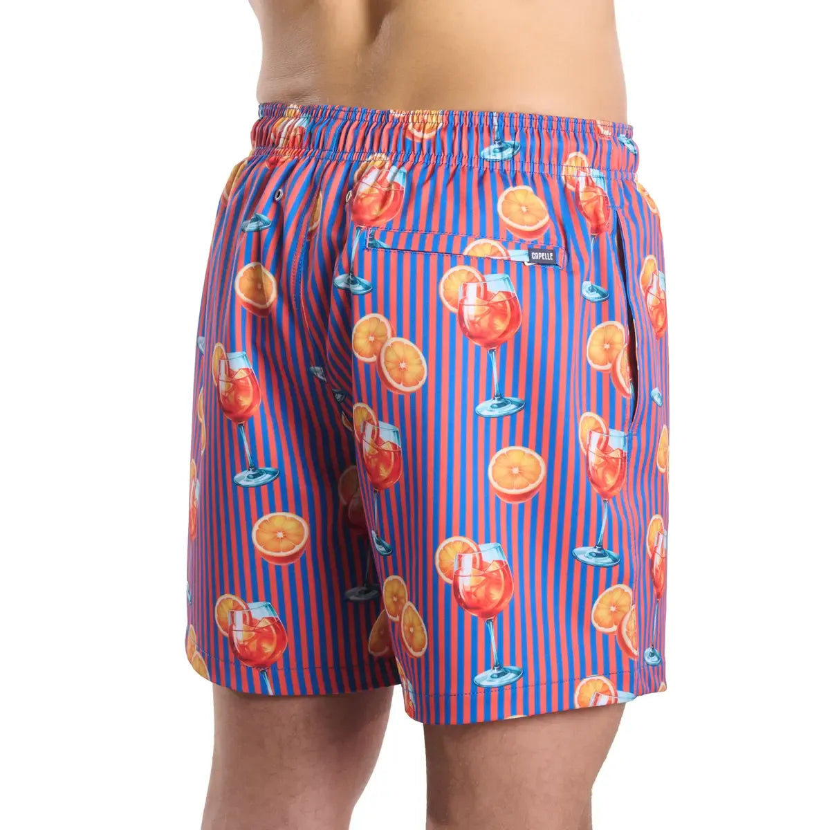 Sunset Spritz, Ocean and Heat men's hybrid swim short in a purple and coral stripe with a spritz cocktail print, back view