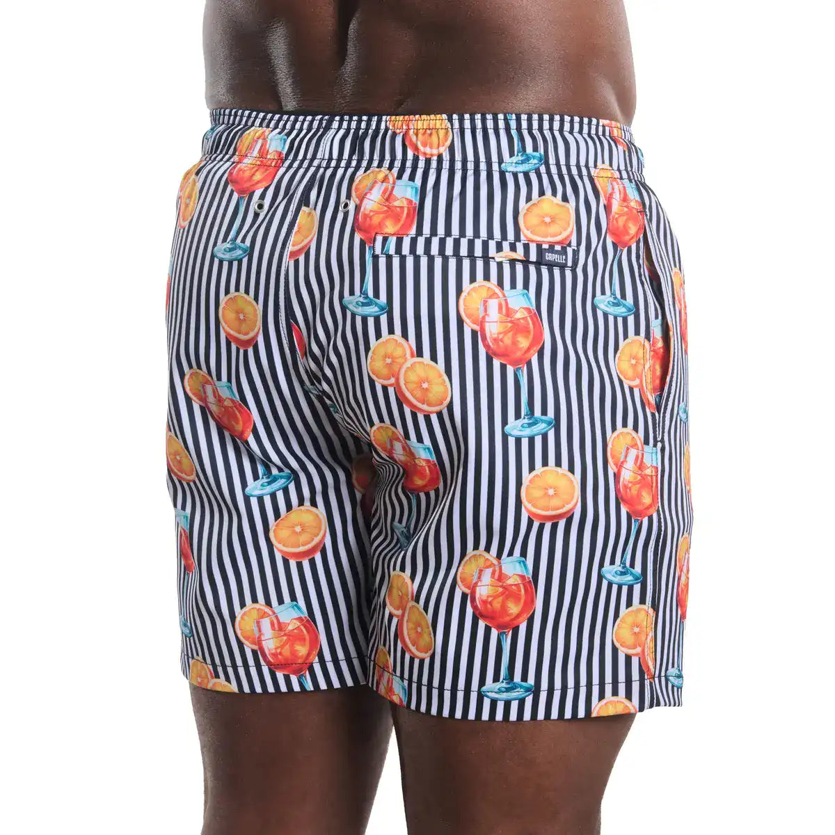 Sunset Spritz, Surf and Storm men's hybrid swim short in a black and white stripe with a spritz cocktail print, back view