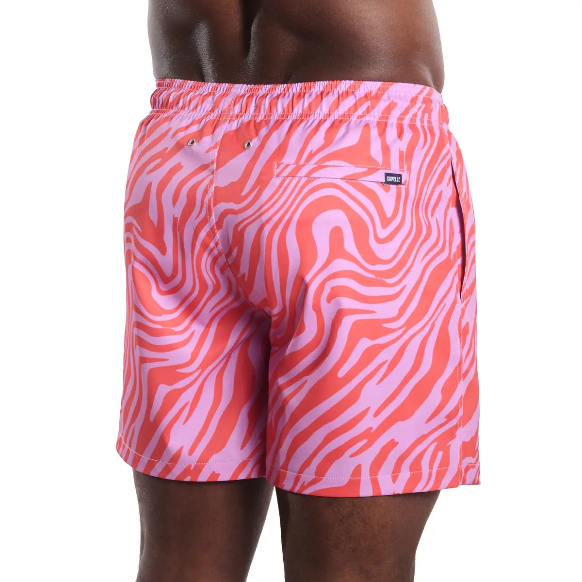 Tropical Swirl, Coral and Orchid men's hybrid swim short in a coral and pink swirled print, back view