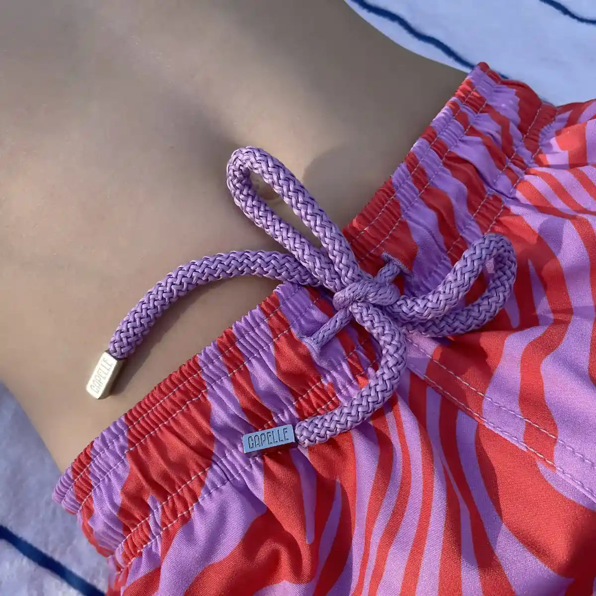 Tropical Swirl, Coral and Orchid boys hybrid short, fabric detail