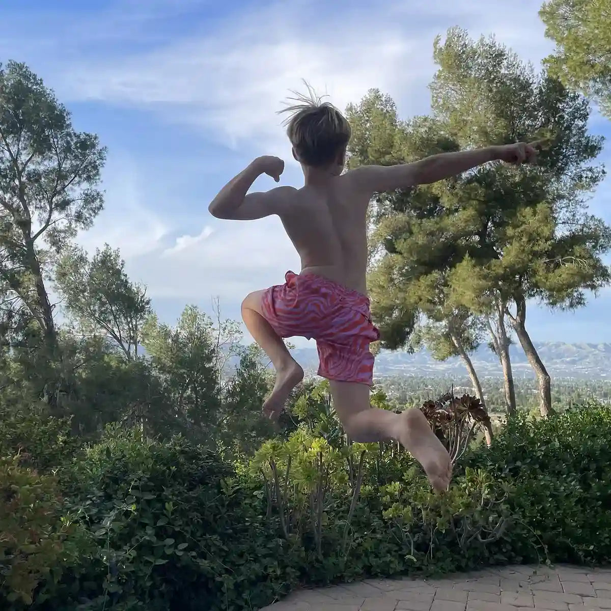 Tropical Swirl, Coral and Orchid boys hybrid short, worn on model