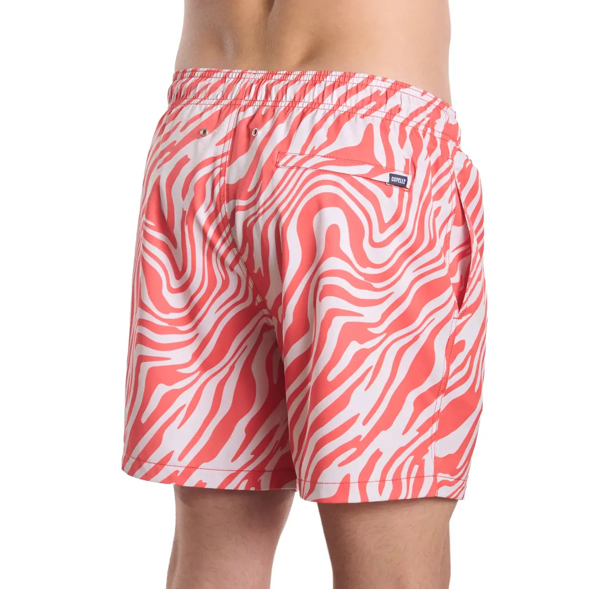 Tropical Swirl, Coral and Sand men's hybrid swim short in a coral and white swirled print, back view