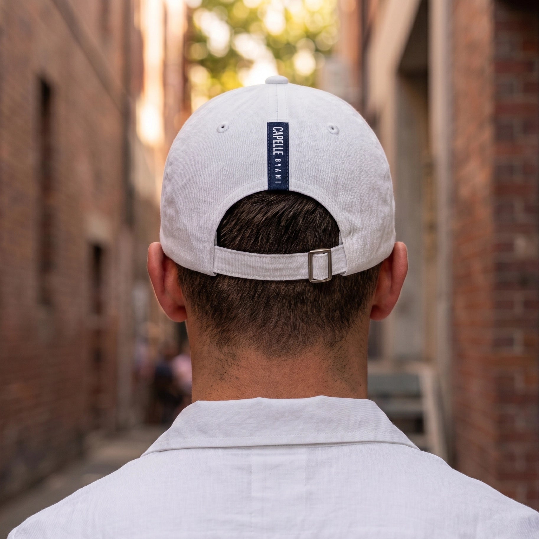 Arctic White Crew Unstructured Cotton Dad Hat from behind, white fabric strap with tri-glide buckle, Capelle Miami